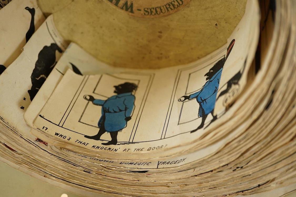 A late 19th century painted tin and mahogany zoetrope by the London Stereoscopic Co. with a number of paper inserts, diameter 30cm